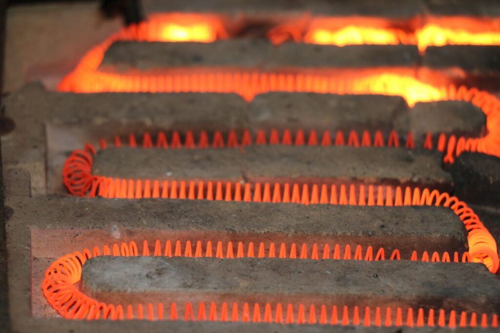 Glowing orange electric heating elements with a coiled structure emitting intense heat
