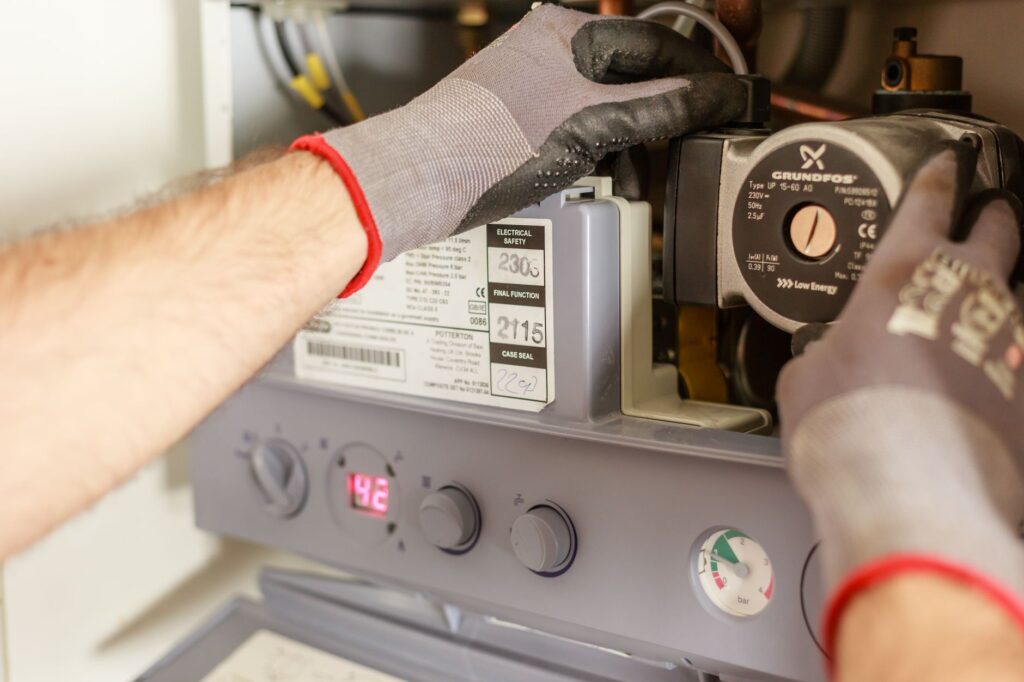 Close-up of a certified technician's gloved hands working on appliance components, representing licensed and insured appliance repair service